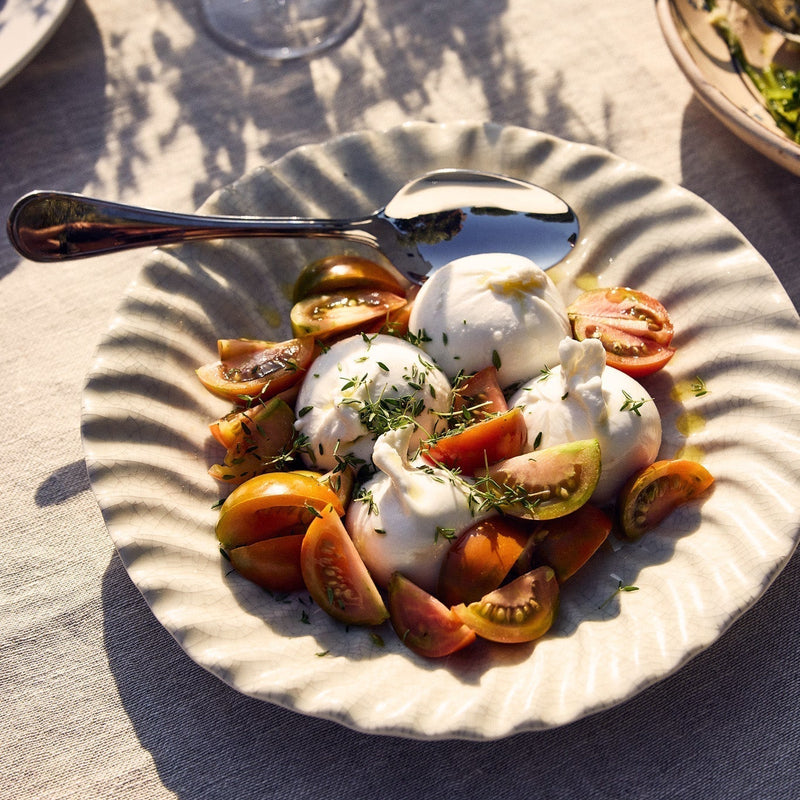 Thyme, tomatoes, burratine and extra virgin olive oil.